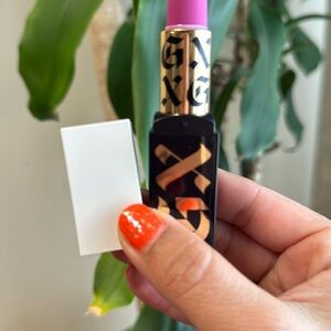 Bold Pink Lipstick with Gold and Black Accents